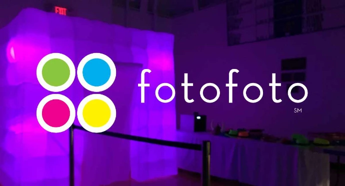 fotofoto logo featuring four colored circles in green, blue, magenta, and yellow next to a white sans-serif font, overlaid on a purple-lit event space with an inflatable photo booth.